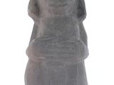 an image of a statue of a woman sitting on a white surface