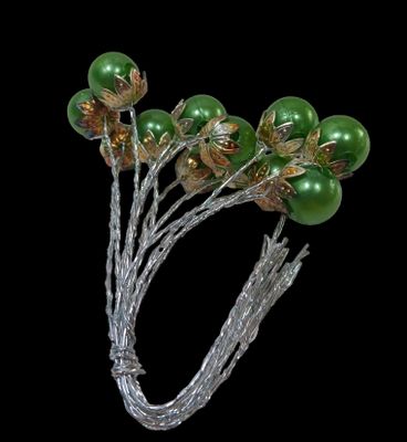 a bunch of green and gold flowers on a silver wire