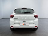 the rear end of a white car in a white room