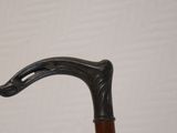 a close up of an old walking stick with a handle