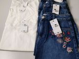two pairs of jeans and a t - shirt are sitting on a table