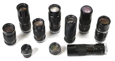 a lot of different types of camera lenses on a white surface