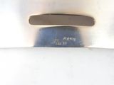 a close up of a knife on a white surface