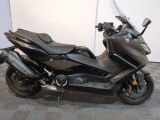 a picture of a black motorcycle parked on a checkered floor