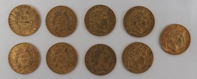 a group of six gold coins sitting on top of a white surface