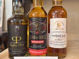 several bottles of different types of alcohol on a shelf in a store