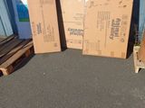 two boxes sitting on the ground next to a pallet of wood