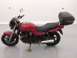 a red motorcycle that is parked in a room
