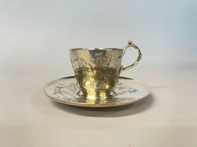 a close up of a cup and saucer on a table