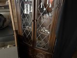 a cabinet that has a glass door and a black curtain
