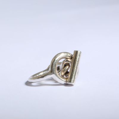 gros plan d'une bague en argent sur une surface blanche
