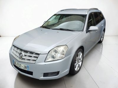 a picture of a silver car parked in a white room