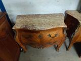 two wooden tables with marble tops in a room