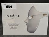 a box with a white mask on it on a table