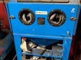 a blue machine that is sitting in a garage