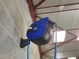 an image of a blue and black air compressor in a building