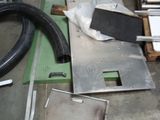 a pile of assorted items on the floor in a garage