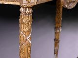 a gold table with a marble top on a black background