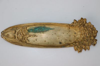 a gold plate with a green design on it