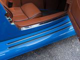 a blue car with a brown leather seat in the back