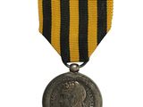 a close up of a medal on a white background with a black and yellow ribbon