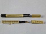 two pens sitting next to each other on a white surface