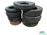 four tires stacked on top of each other on a white background