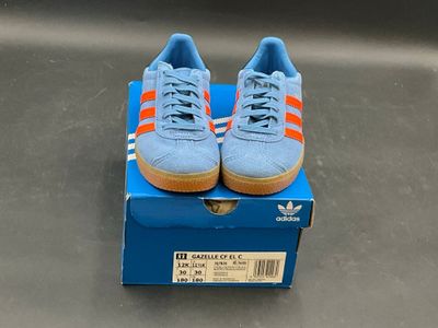 blue box with orange and white adidas sneakers on top of it
