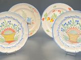 three plates with blue and orange designs on them sitting on a table