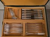 many forks and spoons in a case on the floor