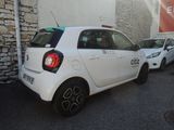 a small white car parked on the side of the street