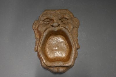 an image of a sculpture of a monkey with its mouth open