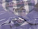 a laptop sitting on a bed covered in a purple blanket