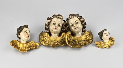three gold figurines of women with heads and hands