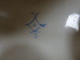 a close up of a plate with a blue design on it