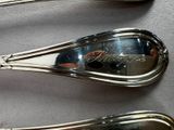 three spoons that are sitting next to each other on a table