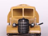 a yellow toy truck that is sitting on a white surface