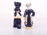 two figurines of a man and a woman standing next to each other