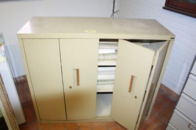 a small cabinet with two doors open in a room