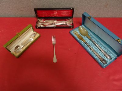 a silverware set on a red table with a fork and knife