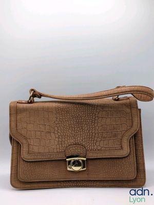 an image of a brown crocodile skin purse with a gold buckle