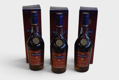 three bottles of wine sitting next to each other on a white surface