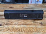 an image of a black speaker sitting on top of a wooden table