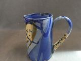 a blue coffee cup with a picture of a man and a woman on it