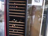 a wine cooler that has many bottles of wine in it