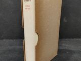 an open book with a white cover sitting on top of a table