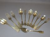 a lot of silver spoons and forks arranged in a circle