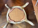 a wooden table with a wooden turtle on it in the middle of a living room