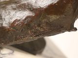 a close up of a bronze statue of a dog