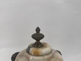 an image of a small bowl with a lid on a white surface
